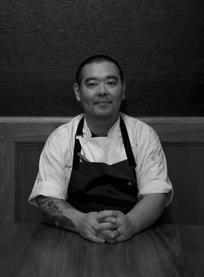 Chef and owner Itaru Nagano seated at a table at Fairchild