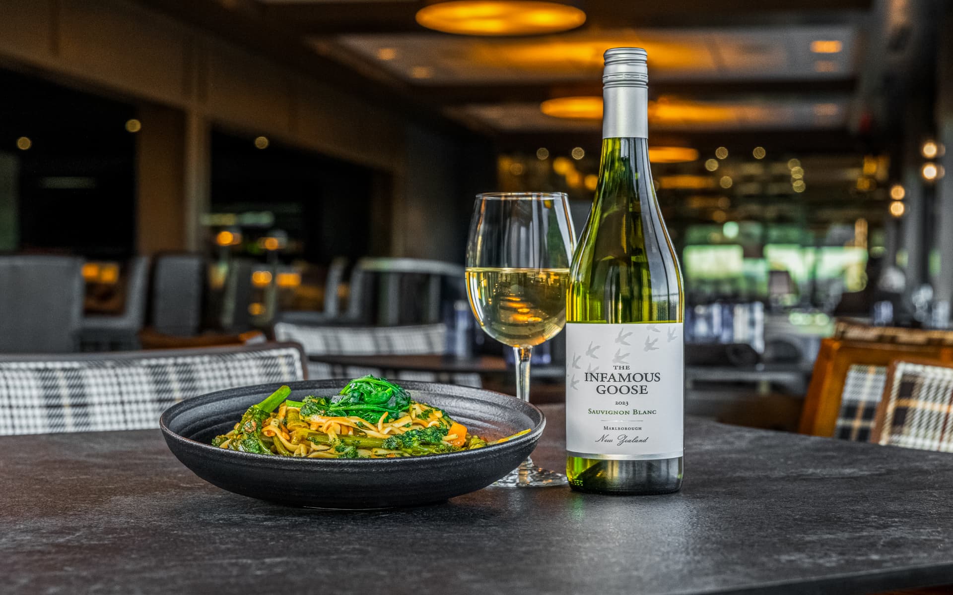 Pasta with broccolini beside a glass of Sauvignon Blanc