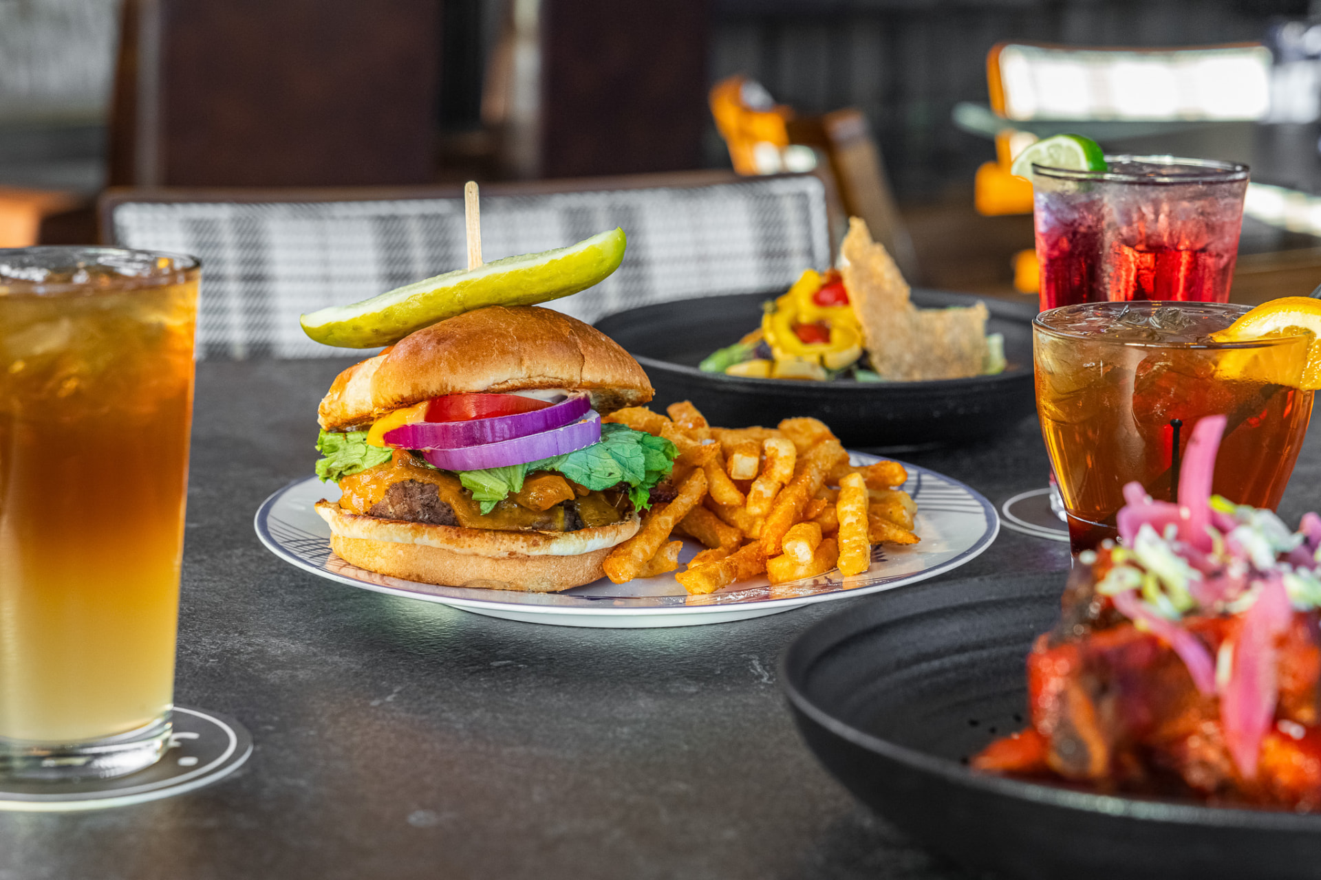 Burger with fries and cocktails at the bar